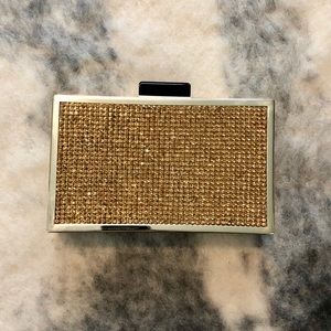 Gold crystal clutch with black enamel clasp